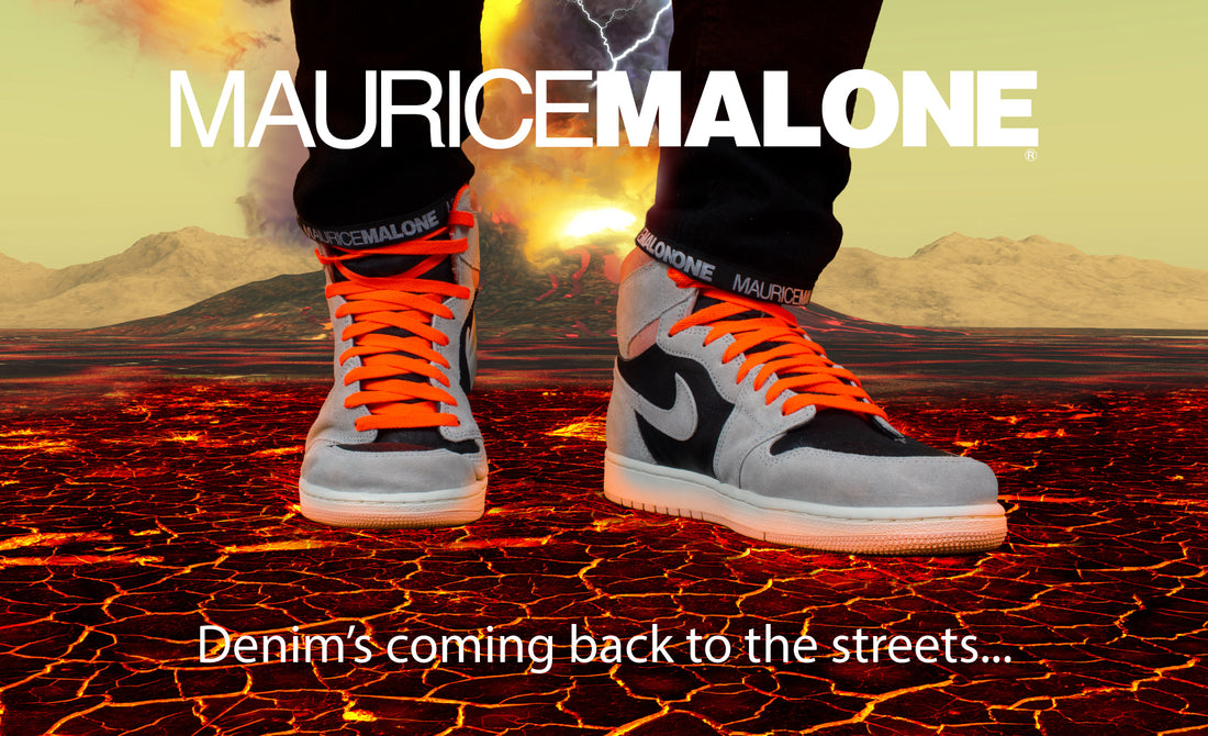 Black logo jeans by designer Maurice Malone walking on hot lava in Nike Air Jordan 1 high retro OG grey & crimson