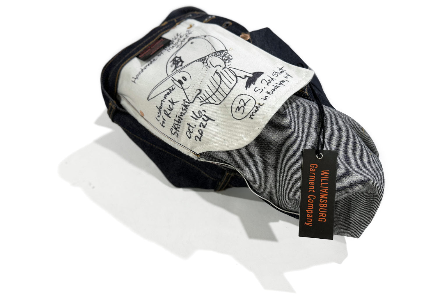 Handmade jeans with Maurice Malone’s signature self-caricature drawn on the pocket bag, used as an example for the Denim Workshop, which teaches people how to make jeans.