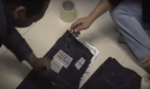 Video of denim designer teaching factory staff how to better hand-sand jeans