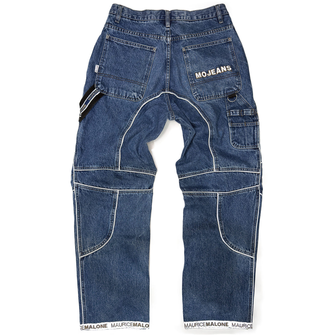 Rear view of 1999 Mojeans Blade Runner jeans showing reflective logo pocket, carpenter loops, cargo pockets, logo cuff hem, and 90s technical hip hop denim design.